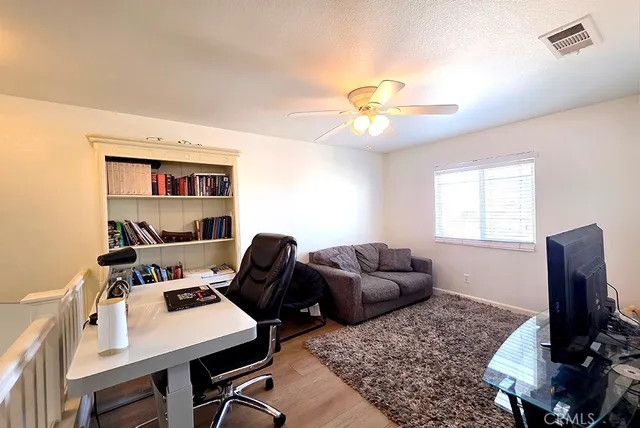 a view of a living room with furniture and wooden floor