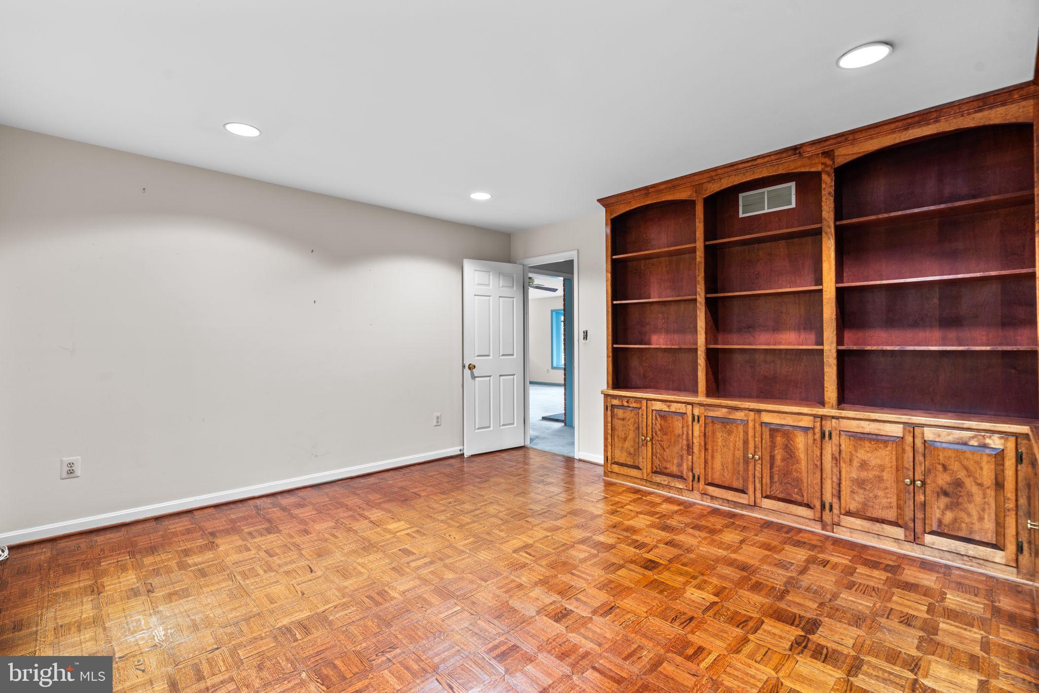 6005 Ten Oaks Road Clarksville, MD 21029 - Photo 56 of 86 a view of an empty room with a bookshelf and a large window