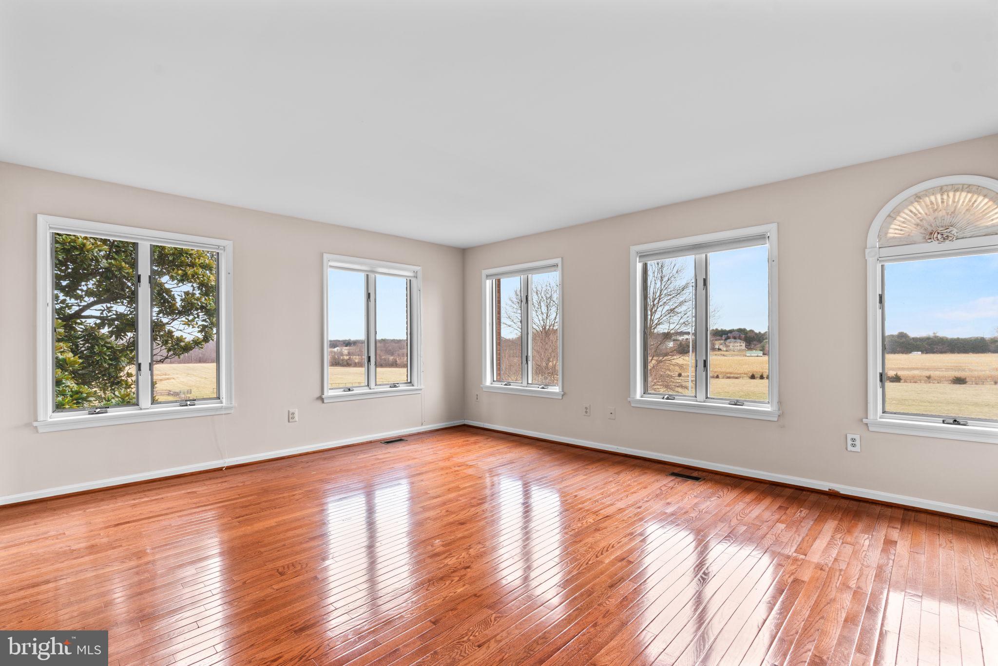 6005 Ten Oaks Road Clarksville, MD 21029 - Photo 58 of 86 a view of an empty room with wooden floor and a window
