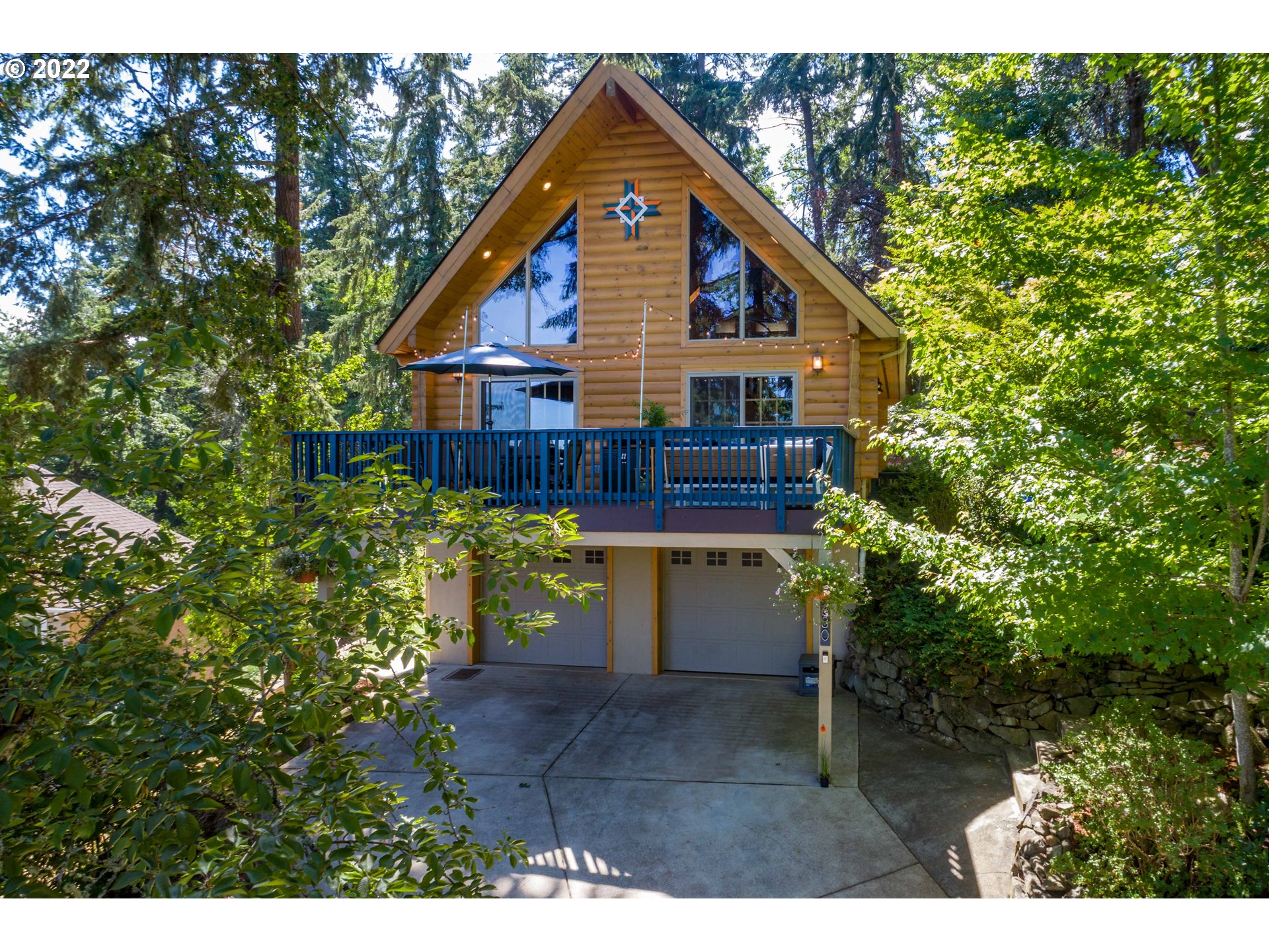 a view of a house with yard and sitting area