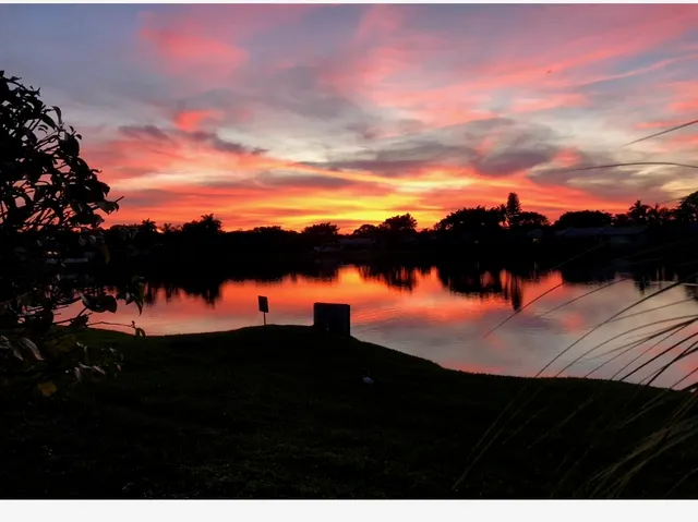 a view of sunset and a yard