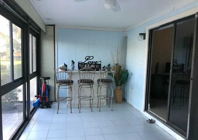 a dining room with furniture and a potted plant