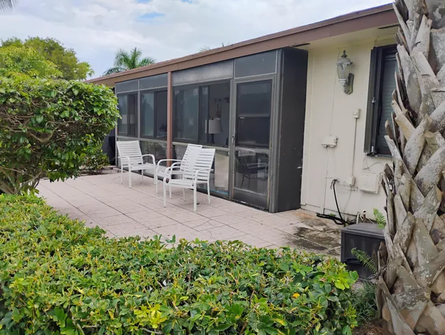 a view of backyard with outdoor seating and plants