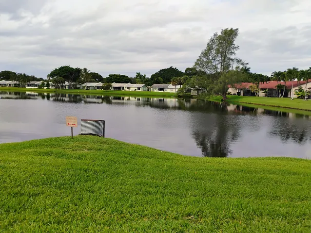 a view of a lake with houses in the back