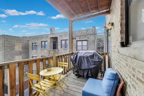a view of a balcony with furniture