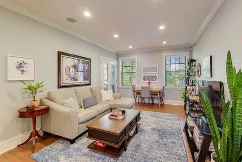 a living room with furniture a lamp and a table