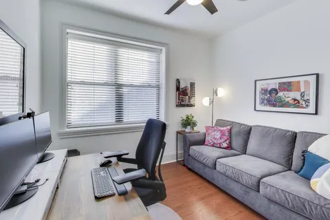 a view of a livingroom with workspace and a couch