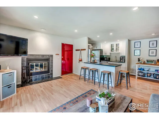 a open kitchen with kitchen island a stove a sink a dining table and chairs