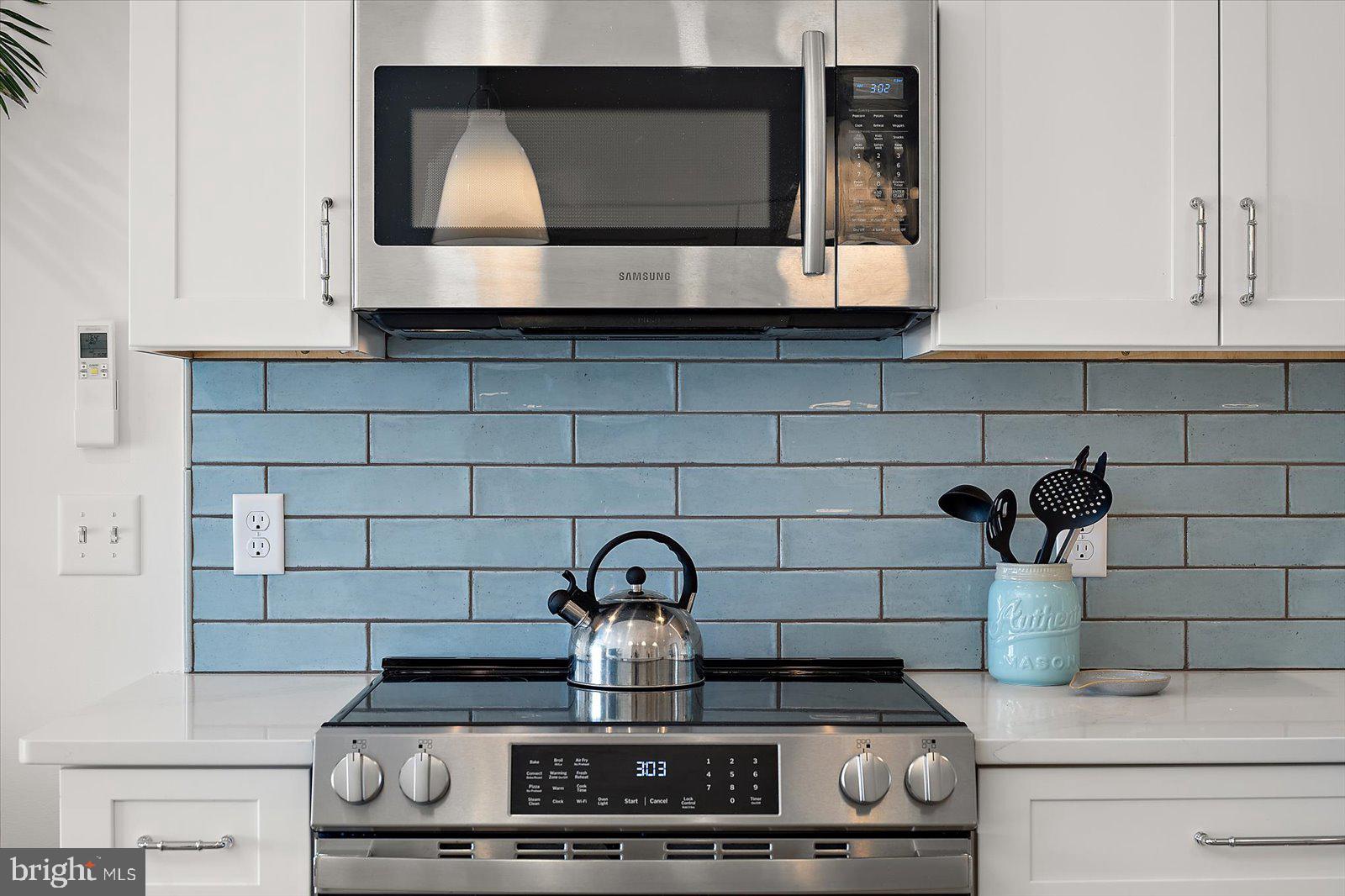 609 Dory Road, Unit 304 Ocean City, MD 21842 - Photo 17 of 55 a kitchen with a stove and a microwave