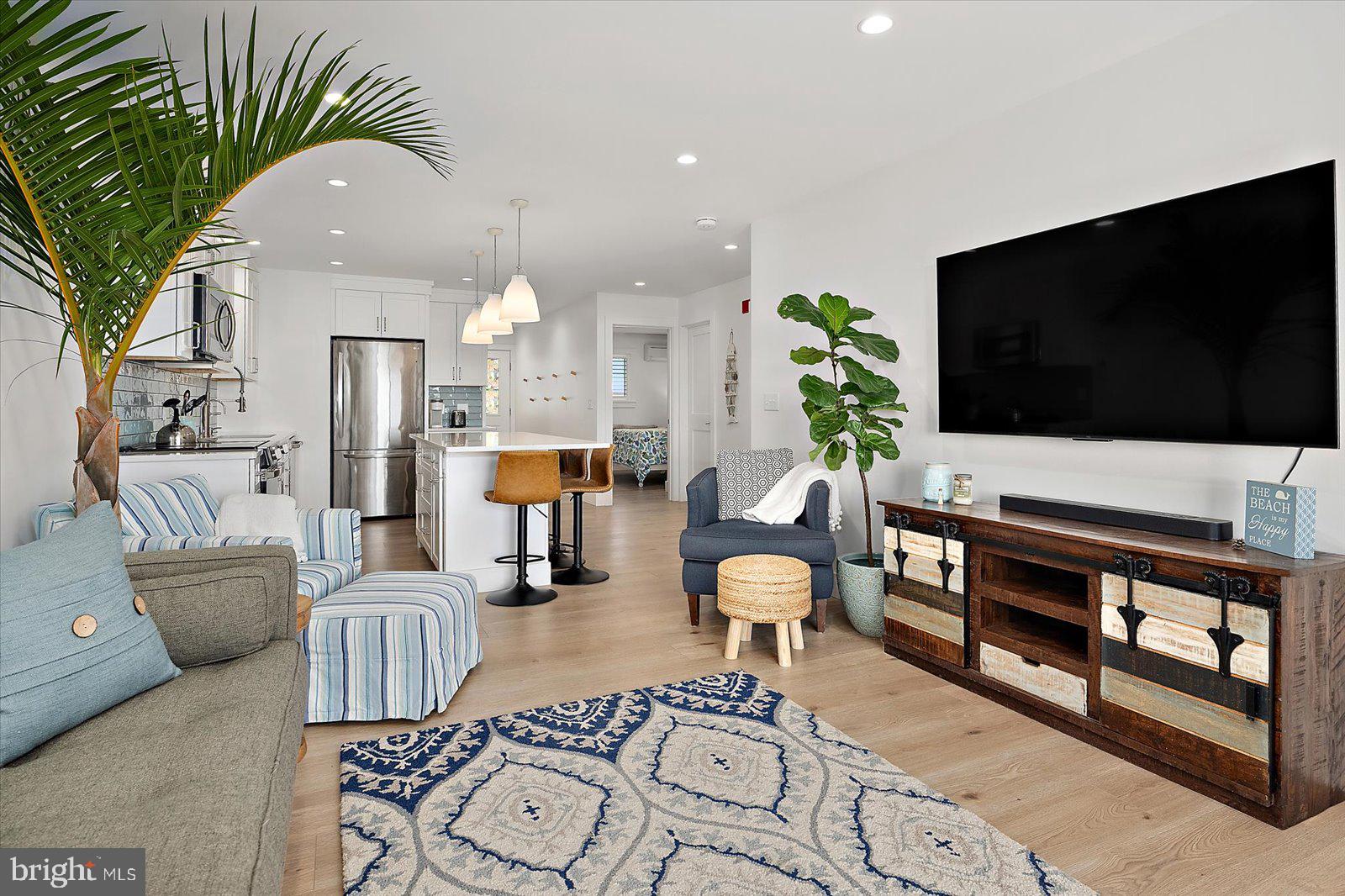 609 Dory Road, Unit 304 Ocean City, MD 21842 - Photo 2 of 55 a living room with furniture and a flat screen tv