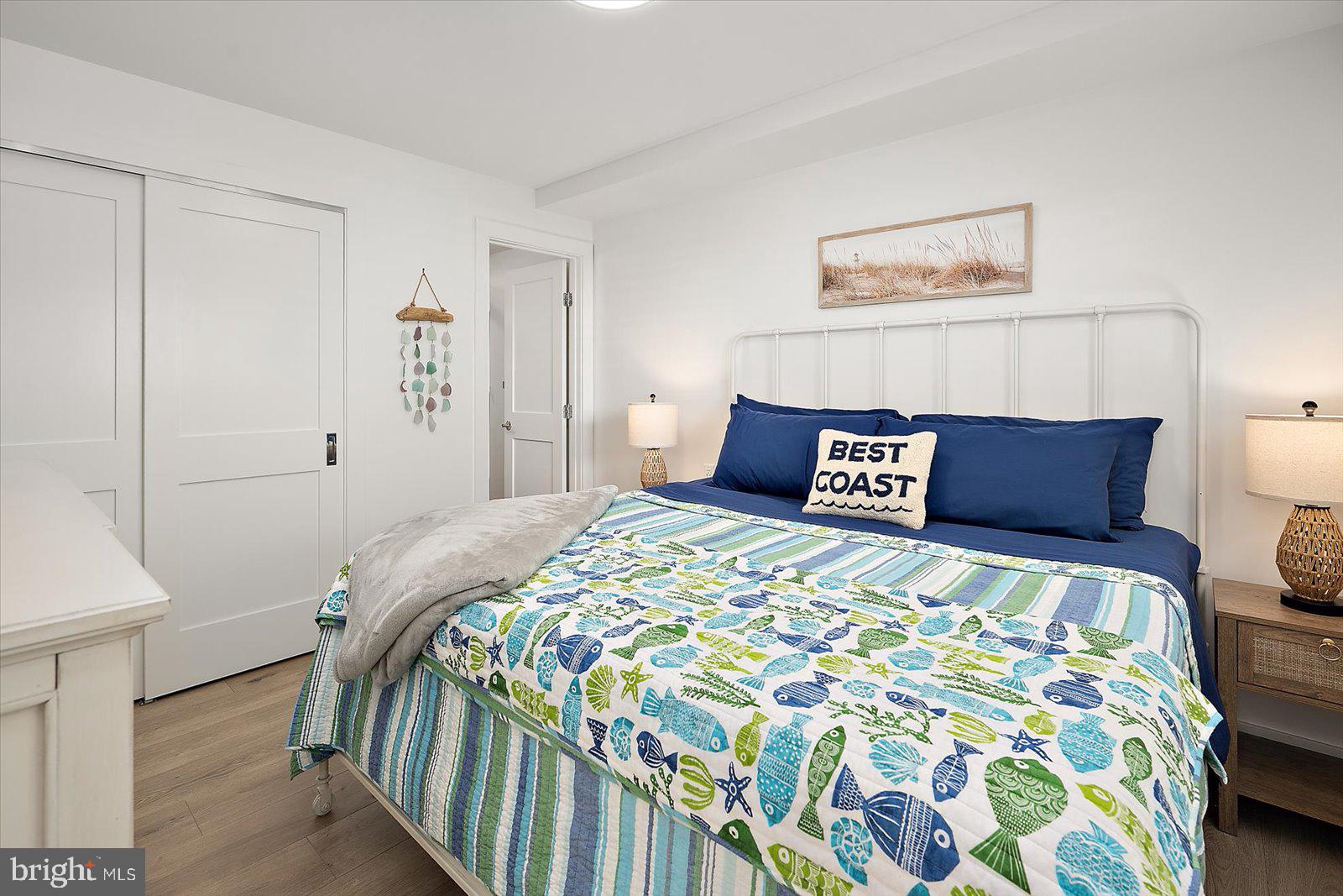 609 Dory Road, Unit 304 Ocean City, MD 21842 - Photo 23 of 55 a bedroom with a bed and a painting on the wall