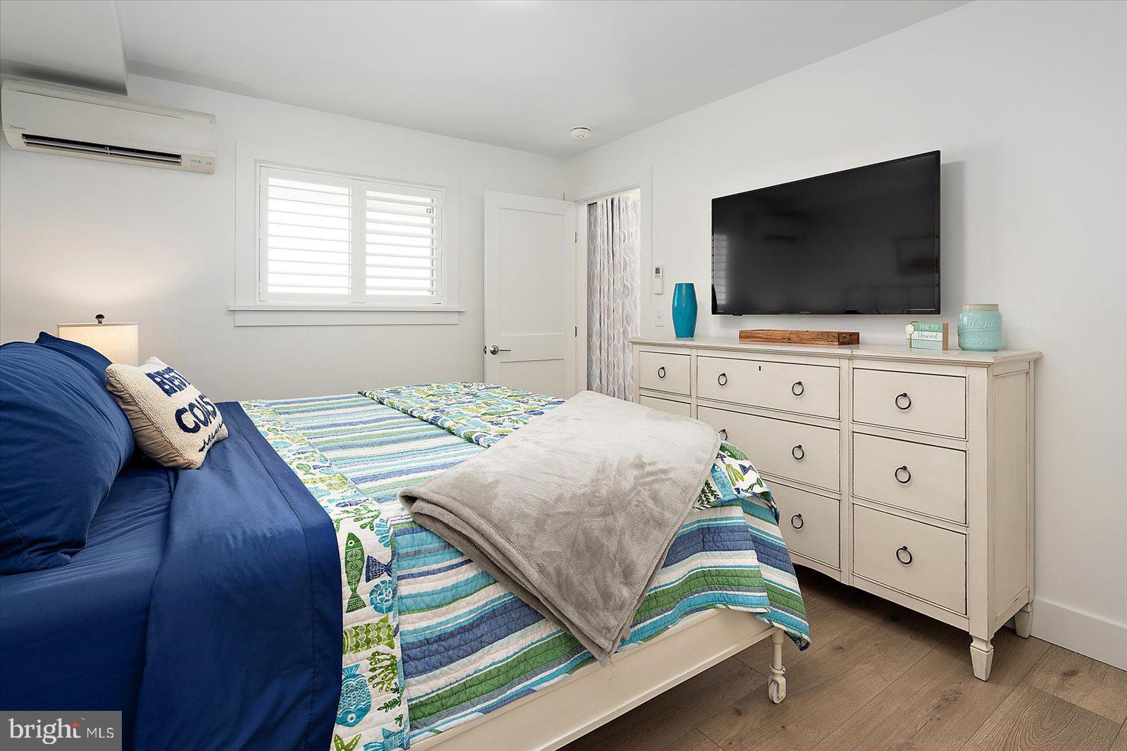 609 Dory Road, Unit 304 Ocean City, MD 21842 - Photo 25 of 55 a bedroom with a bed and a flat screen tv