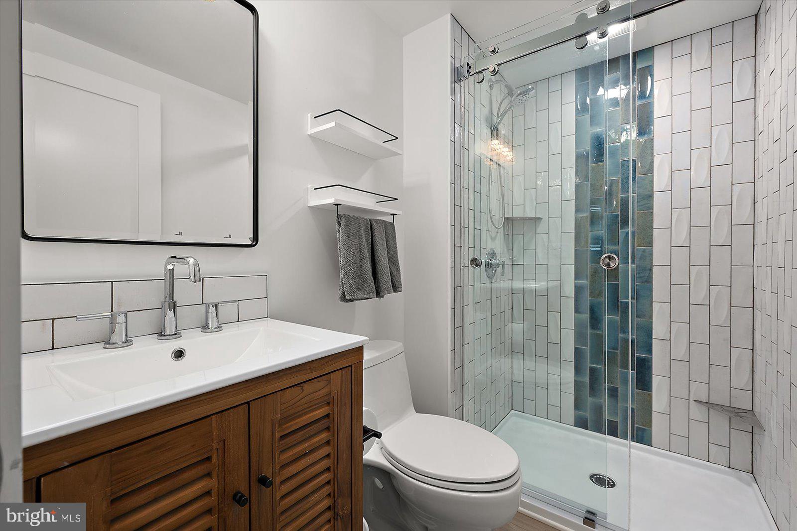 609 Dory Road, Unit 304 Ocean City, MD 21842 - Photo 27 of 55 a bathroom with a sink mirror toilet and shower