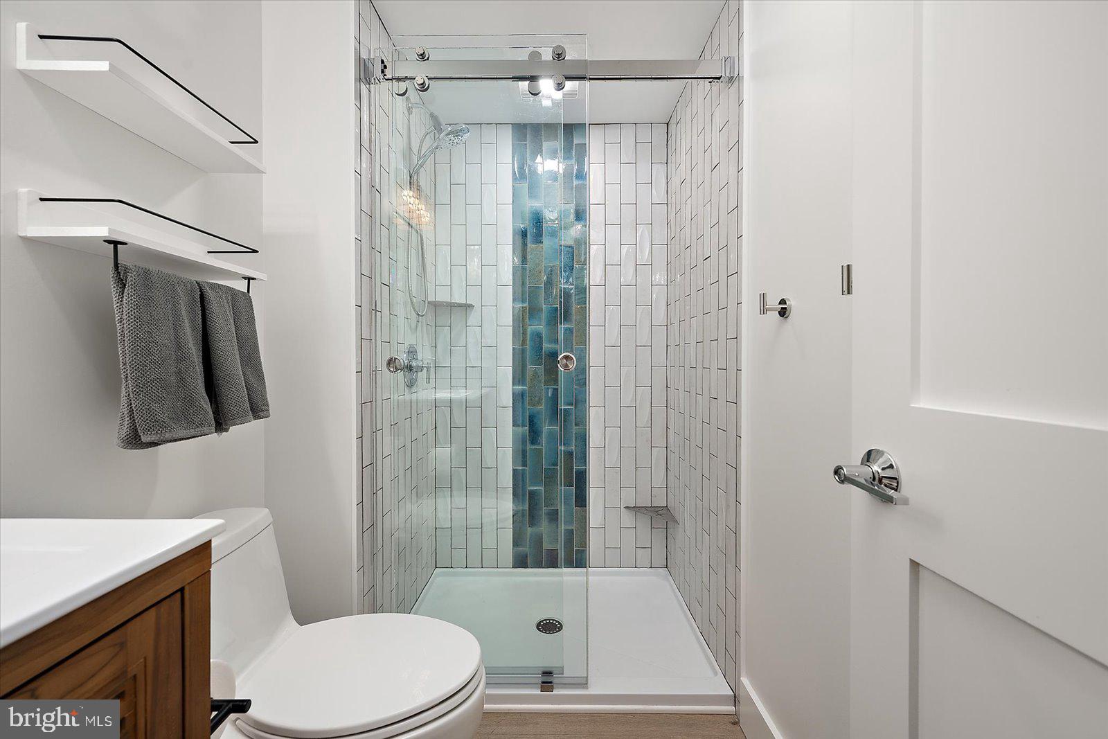 609 Dory Road, Unit 304 Ocean City, MD 21842 - Photo 28 of 55 a bathroom with a shower a toilet and a sink