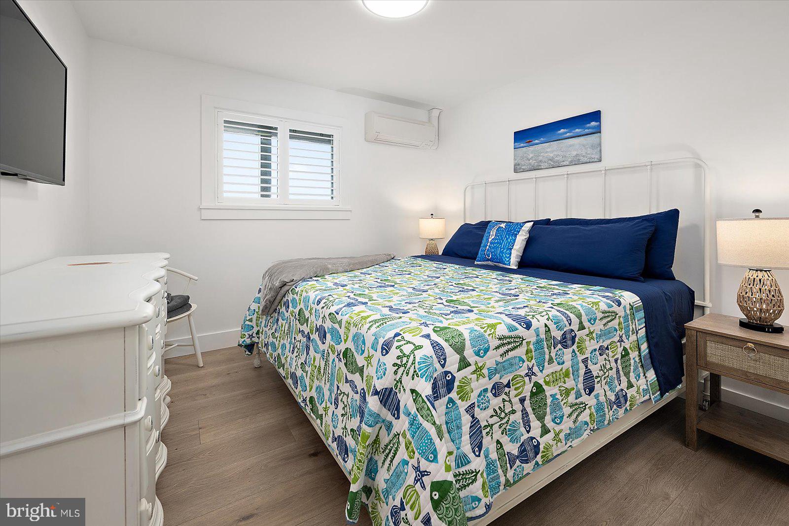 609 Dory Road, Unit 304 Ocean City, MD 21842 - Photo 29 of 55 a bedroom with a bed and a painting on the wall