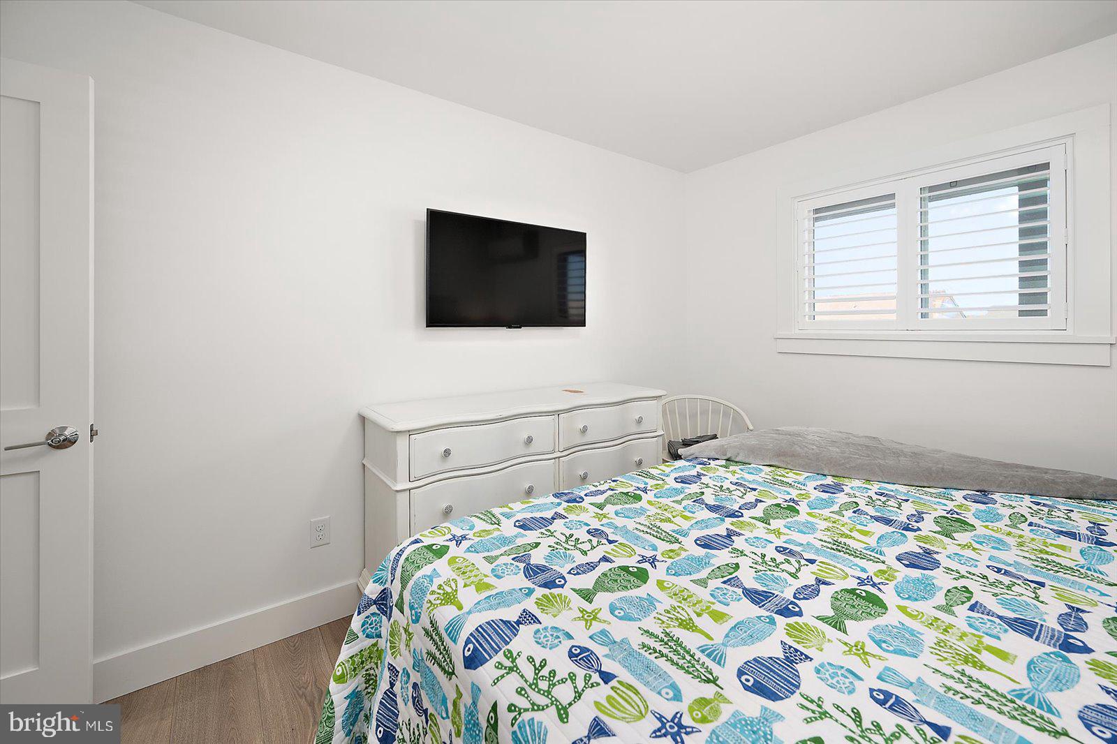 609 Dory Road, Unit 304 Ocean City, MD 21842 - Photo 30 of 55 a bedroom with a bed and a flat screen tv