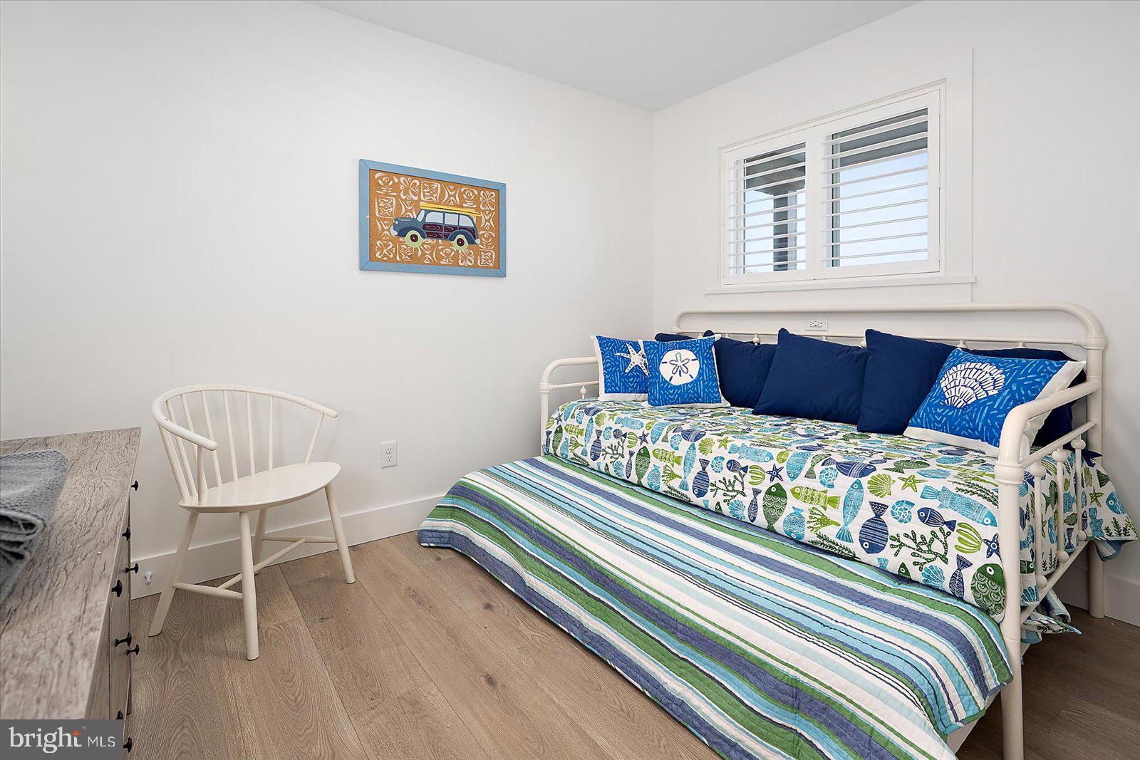 609 Dory Road, Unit 304 Ocean City, MD 21842 - Photo 39 of 55 a bedroom with a bed and a chair