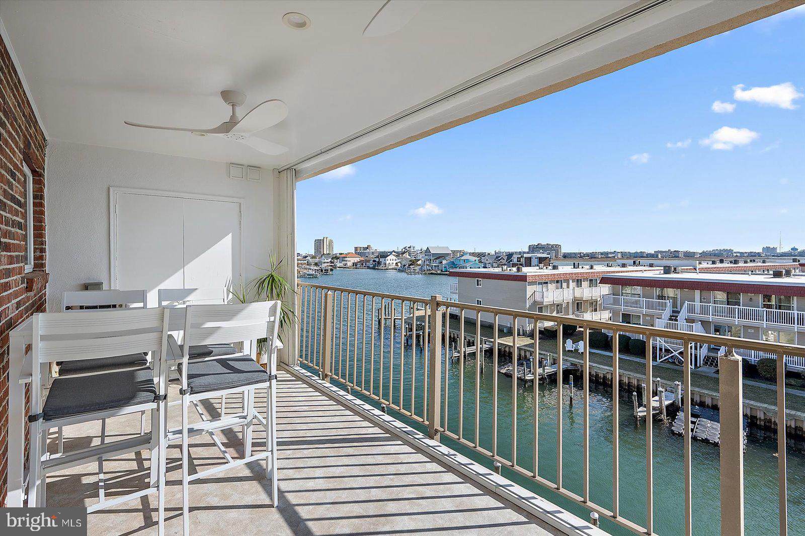 609 Dory Road, Unit 304 Ocean City, MD 21842 - Photo 44 of 55 a balcony with wooden floor outdoor seating and city view