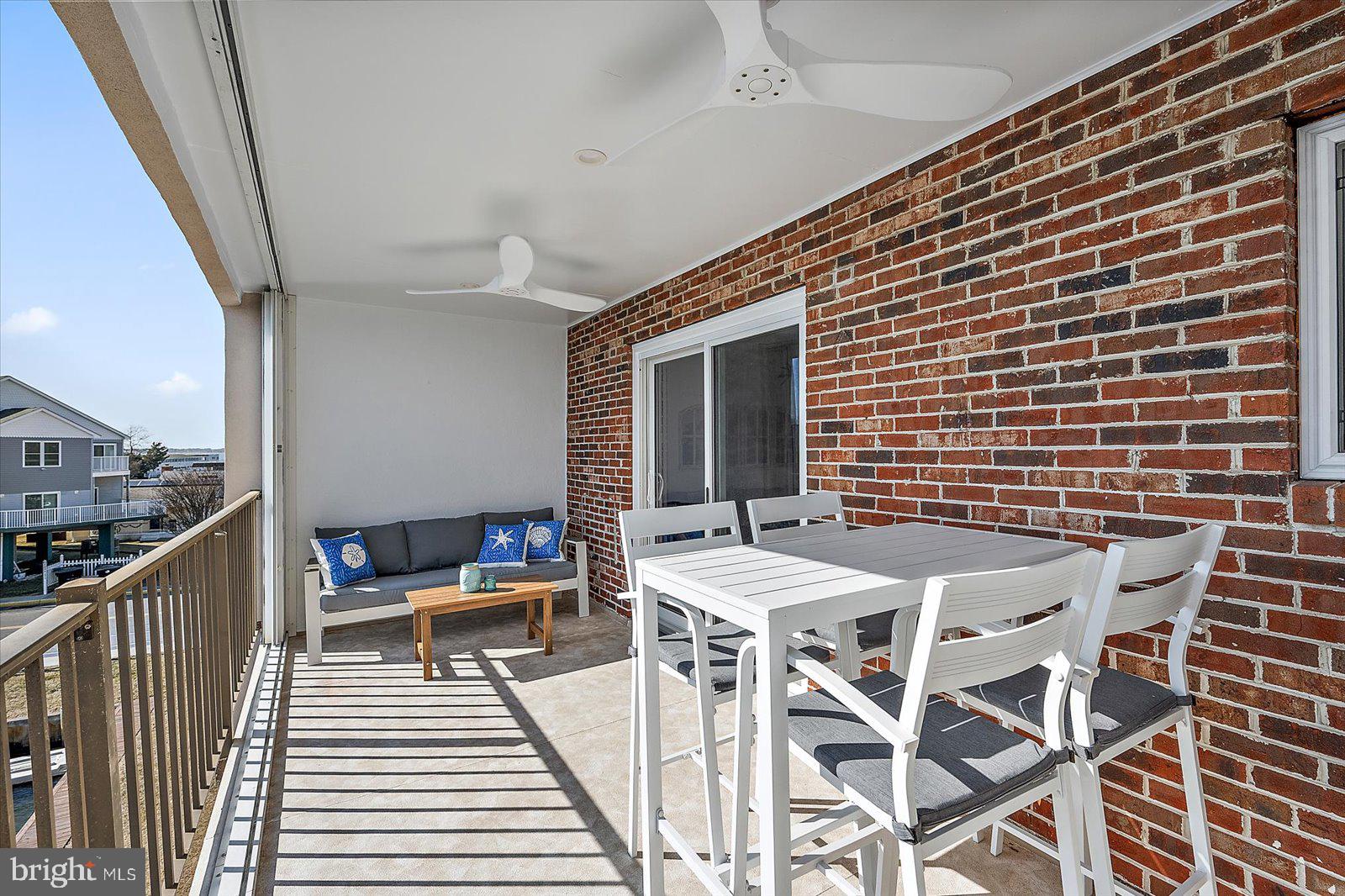 609 Dory Road, Unit 304 Ocean City, MD 21842 - Photo 47 of 55 a balcony with table and chairs