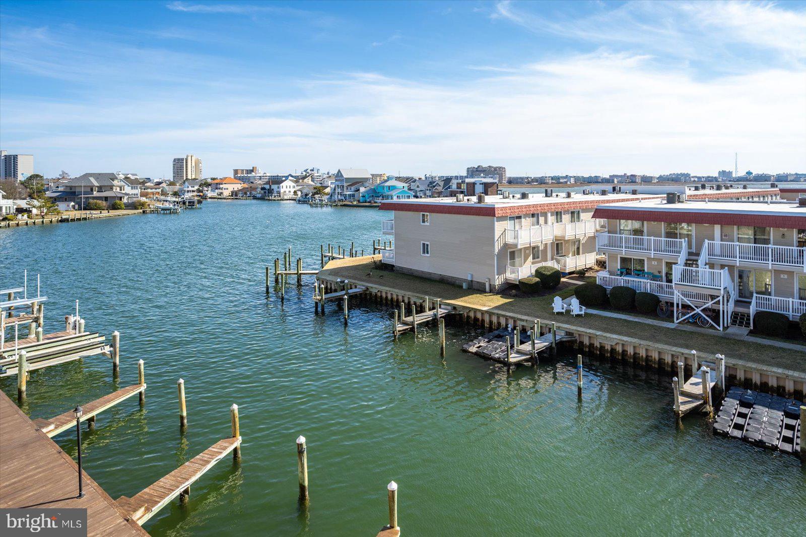 609 Dory Road, Unit 304 Ocean City, MD 21842 - Photo 51 of 55 a view of a lake with a table and chairs