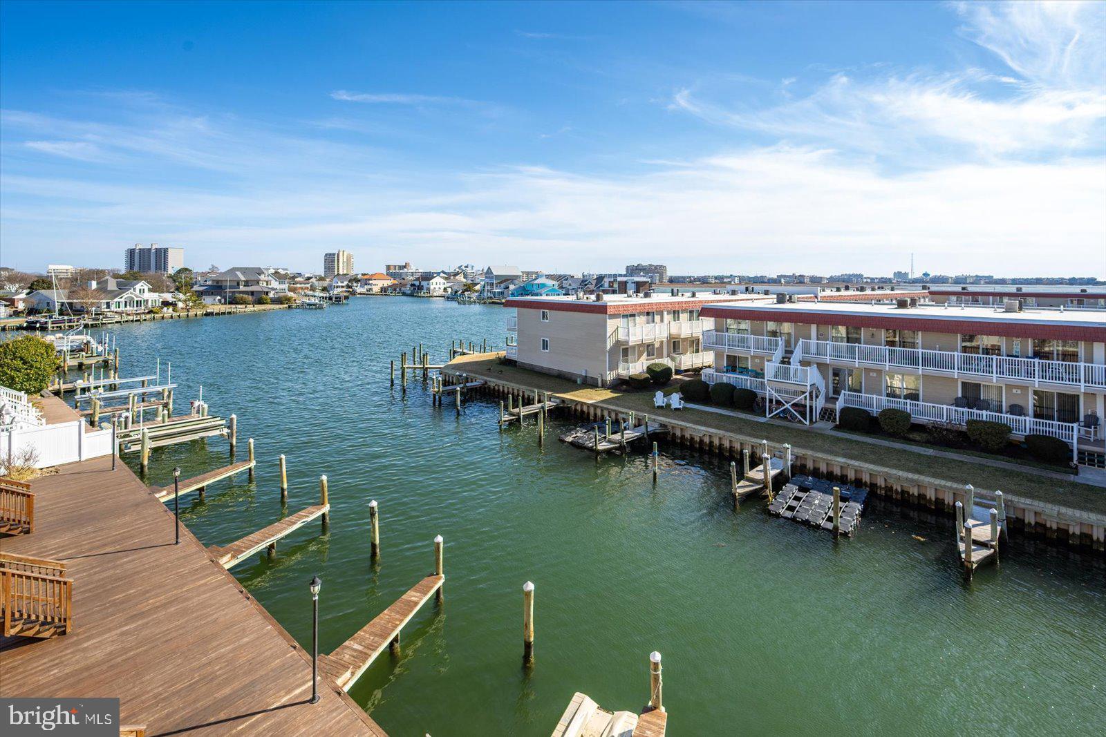 609 Dory Road, Unit 304 Ocean City, MD 21842 - Photo 52 of 55 a view of a lake with a table and chairs