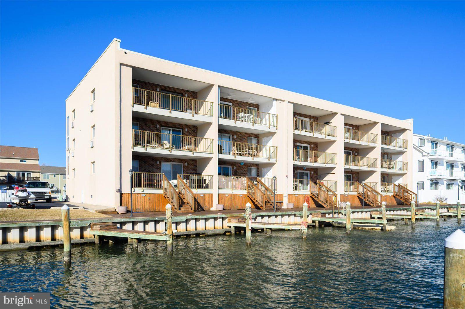 609 Dory Road, Unit 304 Ocean City, MD 21842 - Photo 55 of 55 a blue swimming pool with outdoor seating and yard