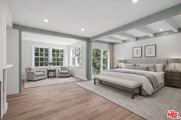 a spacious bedroom with a bed and a couch