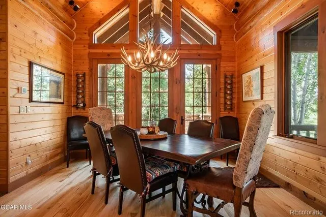 a view of a dining room with furniture wooden floor and chandelier