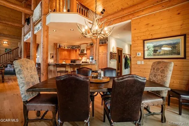a view of a dining room with furniture and chandelier