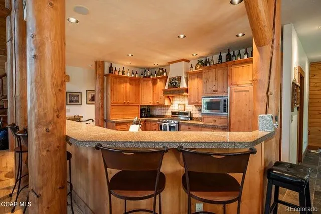 a kitchen with a sink a table and chairs