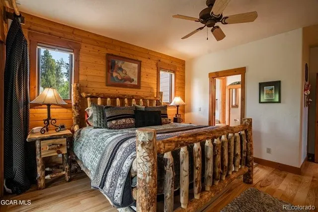 a bedroom with a bed next to a window