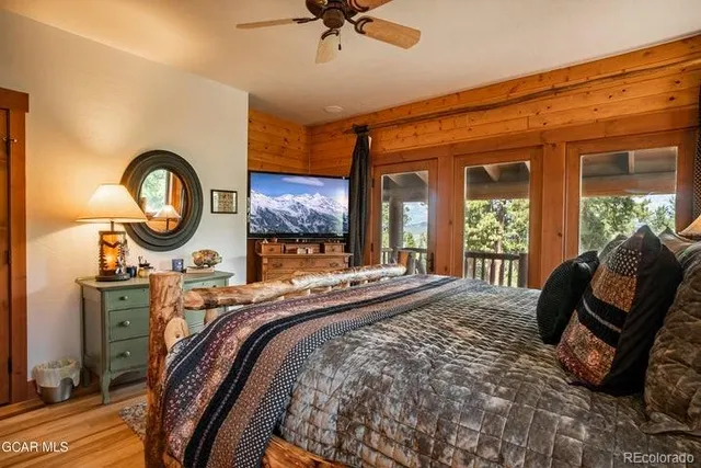 a bed sitting in a spacious bedroom next to a window