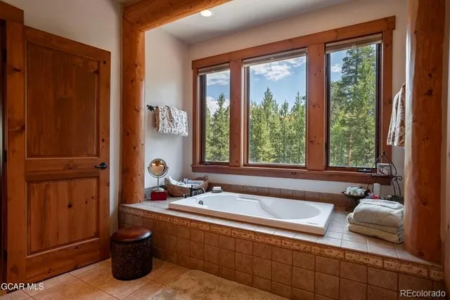 a bath tub sitting in a bathroom next to a window