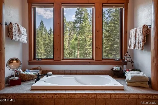 a bathroom with a bathtub and next to a window