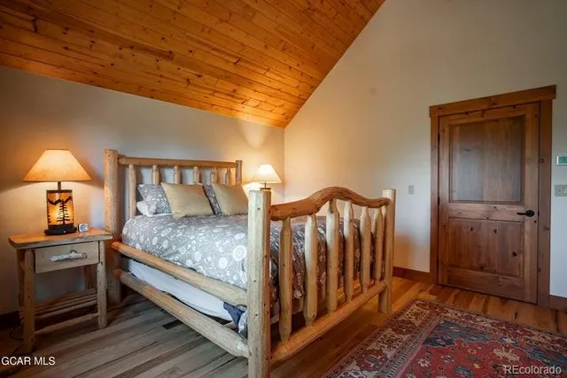 a bedroom with bed and a night stand