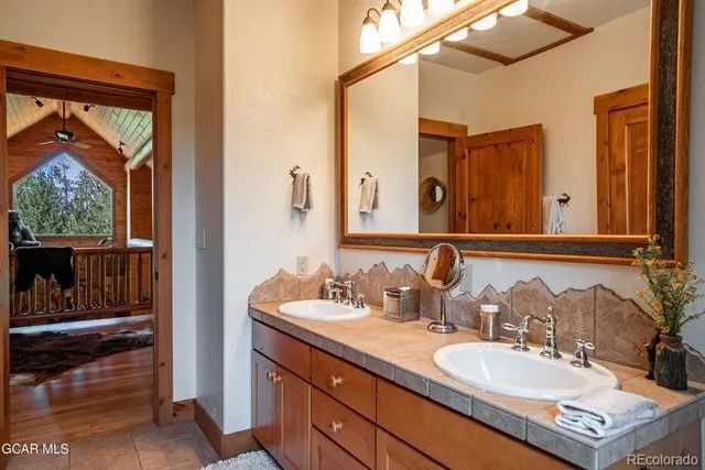 a bathroom with a double vanity sink and a mirror