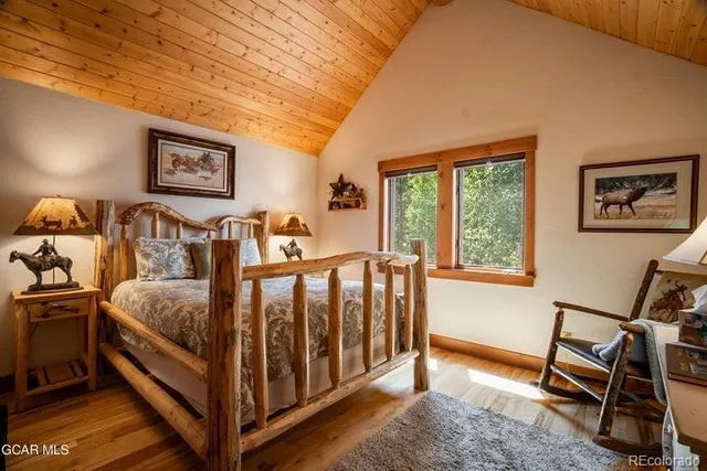 a bed sitting in a bedroom next to a window