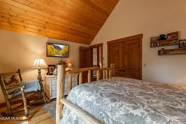 a bedroom with a bed a desk and chair