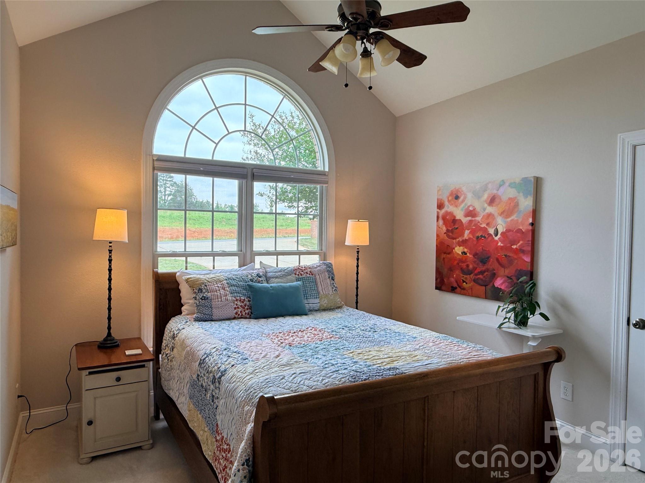 183 Burl Bridges Road Forest City, NC 28043 - Photo 12 of 33 a bedroom with a bed and a chandelier
