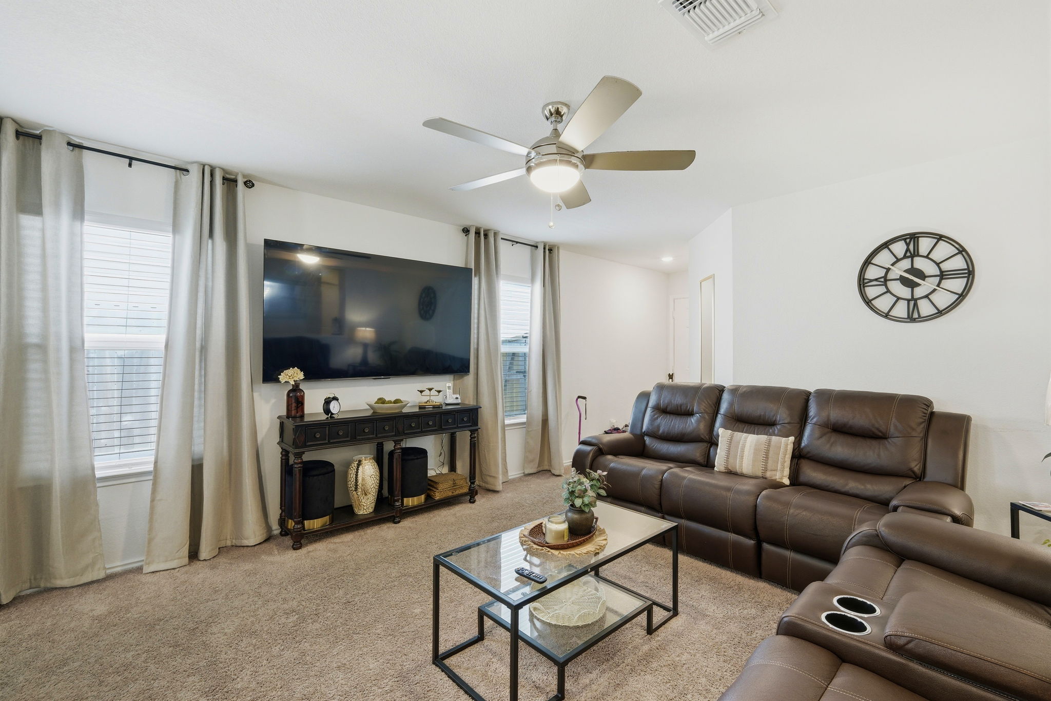 220 Lucky Texan Road Jarrell, TX 76537 - Photo 4 of 19 Comfortable living space featuring soft carpeting and a ceiling fan, ideal for relaxation.