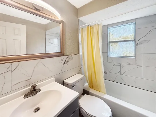 a bathroom with a sink a toilet and tub