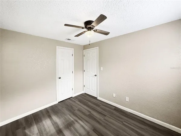 a view of a room with wooden floor