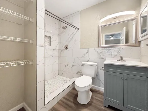 a bathroom with a sink toilet and shower