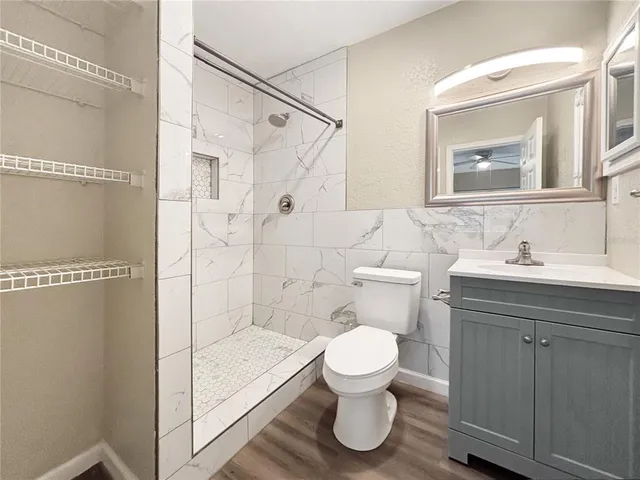 a bathroom with a sink toilet and shower