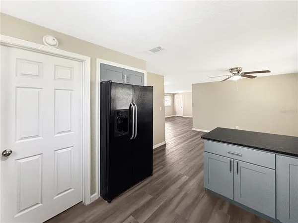 a kitchen with a refrigerator and cabinets