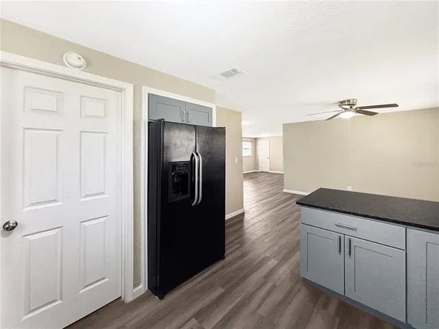 a kitchen with a refrigerator and cabinets