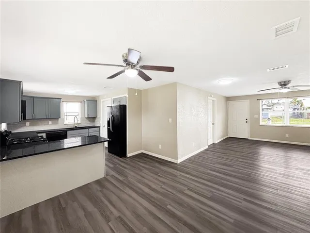a view of a kitchen with a sink and a window