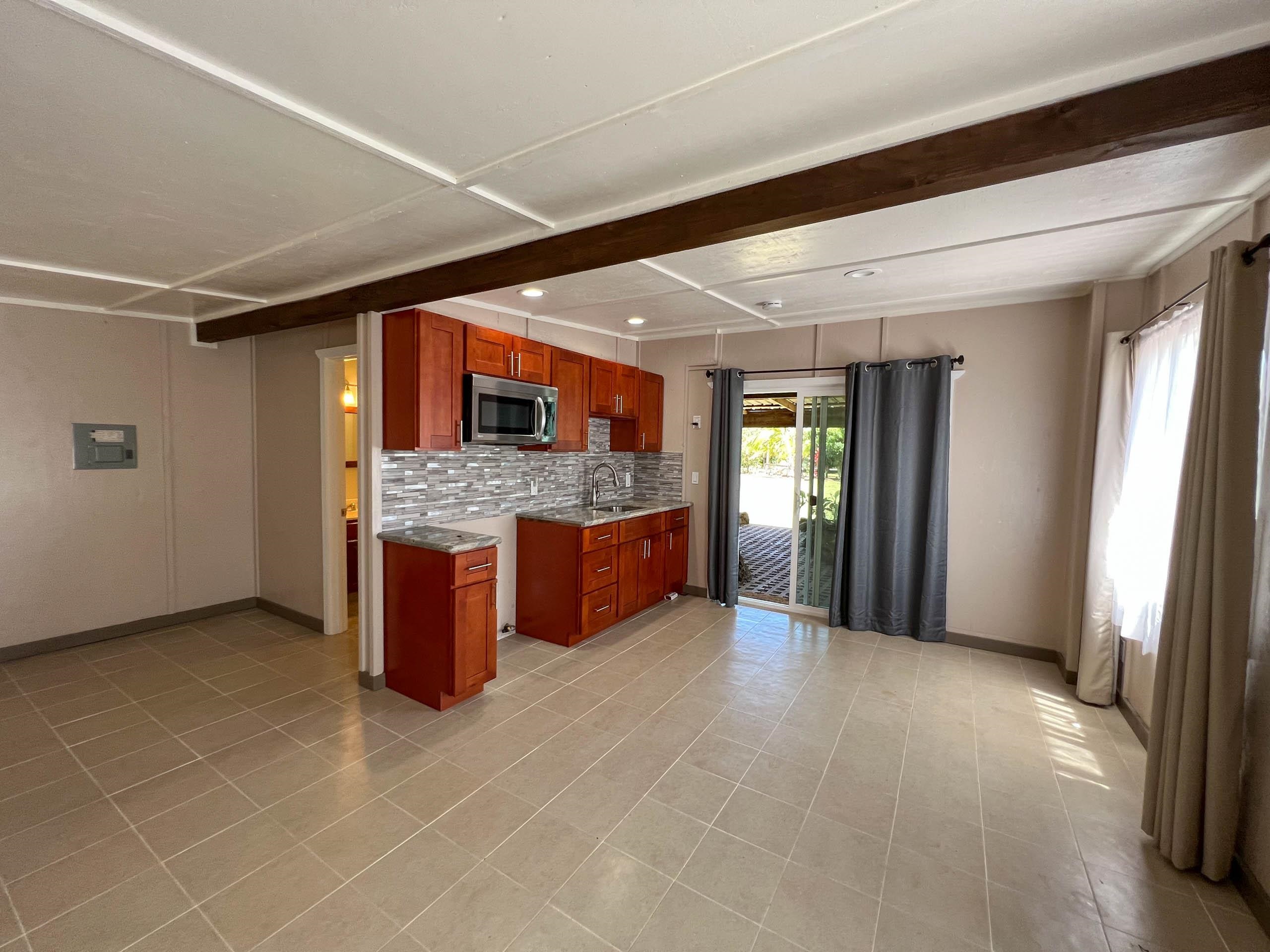 2594 Puuomalei Road Haiku, HI 96708 - Photo 23 of 30 a spacious bathroom with a granite countertop sink and a mirror