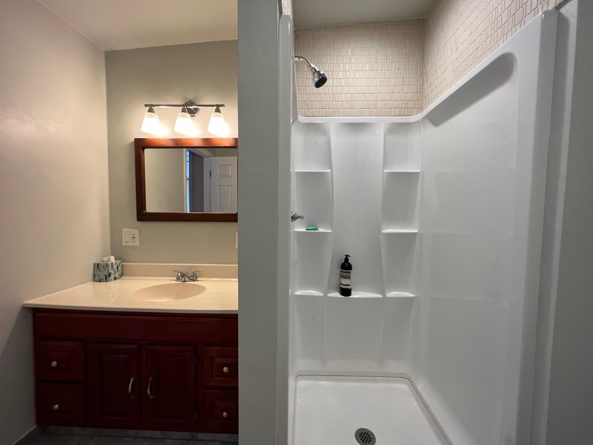 2594 Puuomalei Road Haiku, HI 96708 - Photo 24 of 30 a bathroom with a sink a large mirror and shower