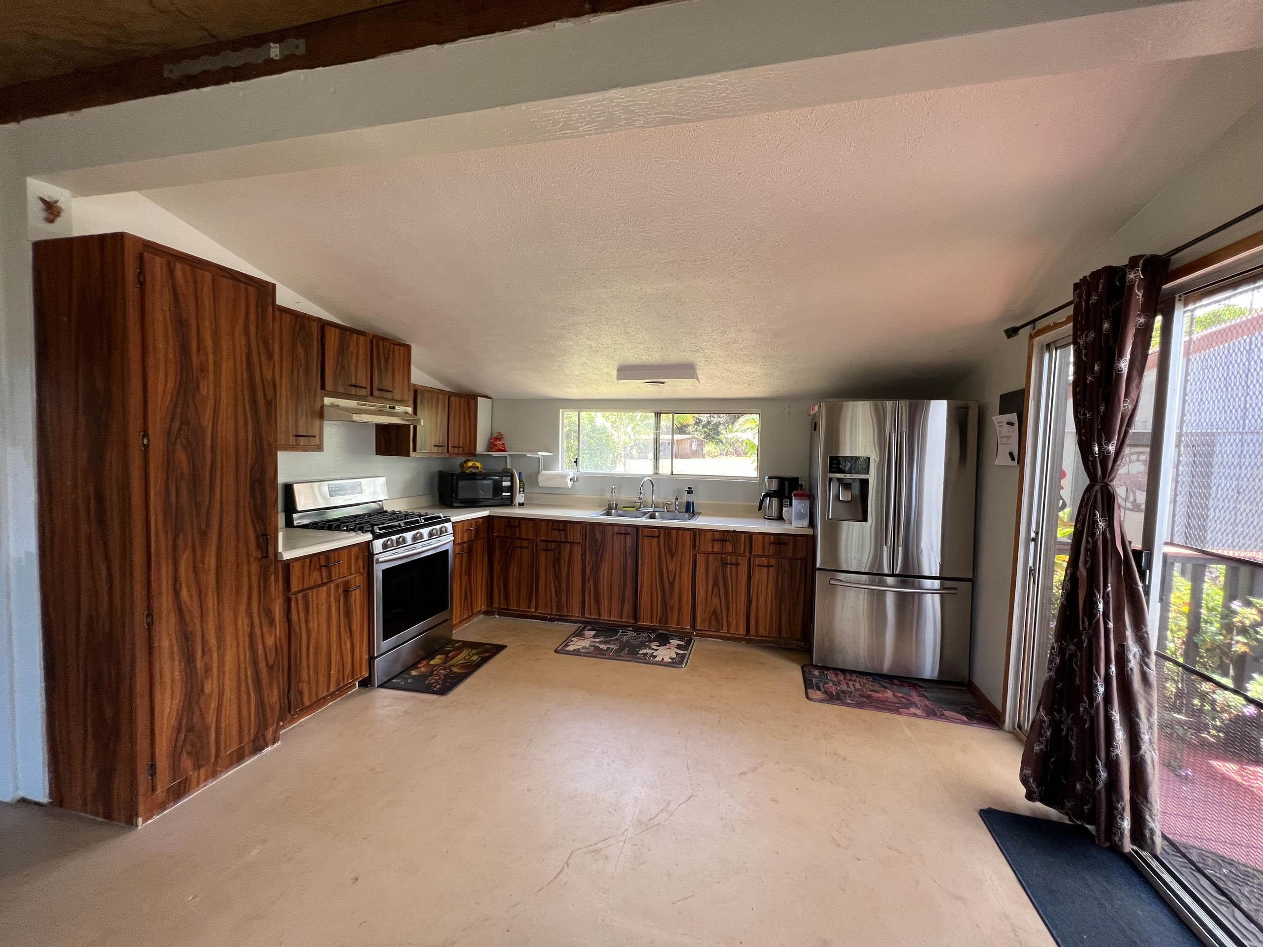 2594 Puuomalei Road Haiku, HI 96708 - Photo 7 of 30 a kitchen with stainless steel appliances a refrigerator and a stove top oven